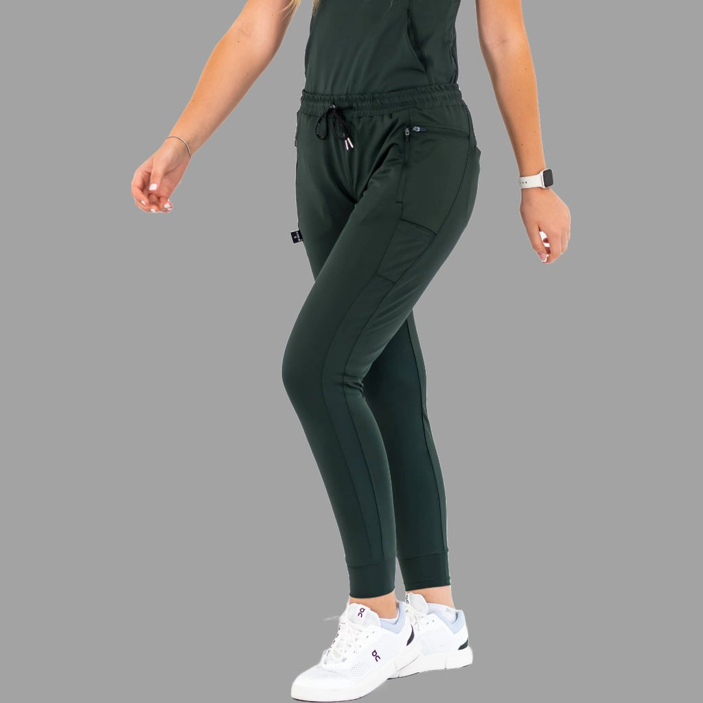 Full front view of women's scrub joggers 920 super stretch bottle green with model walking.