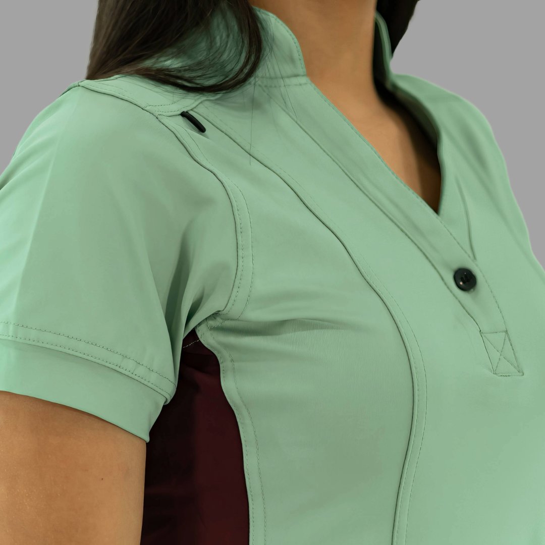 Acercamiento al hombro y cuello de la filipina médica 930 verde menta y vino.